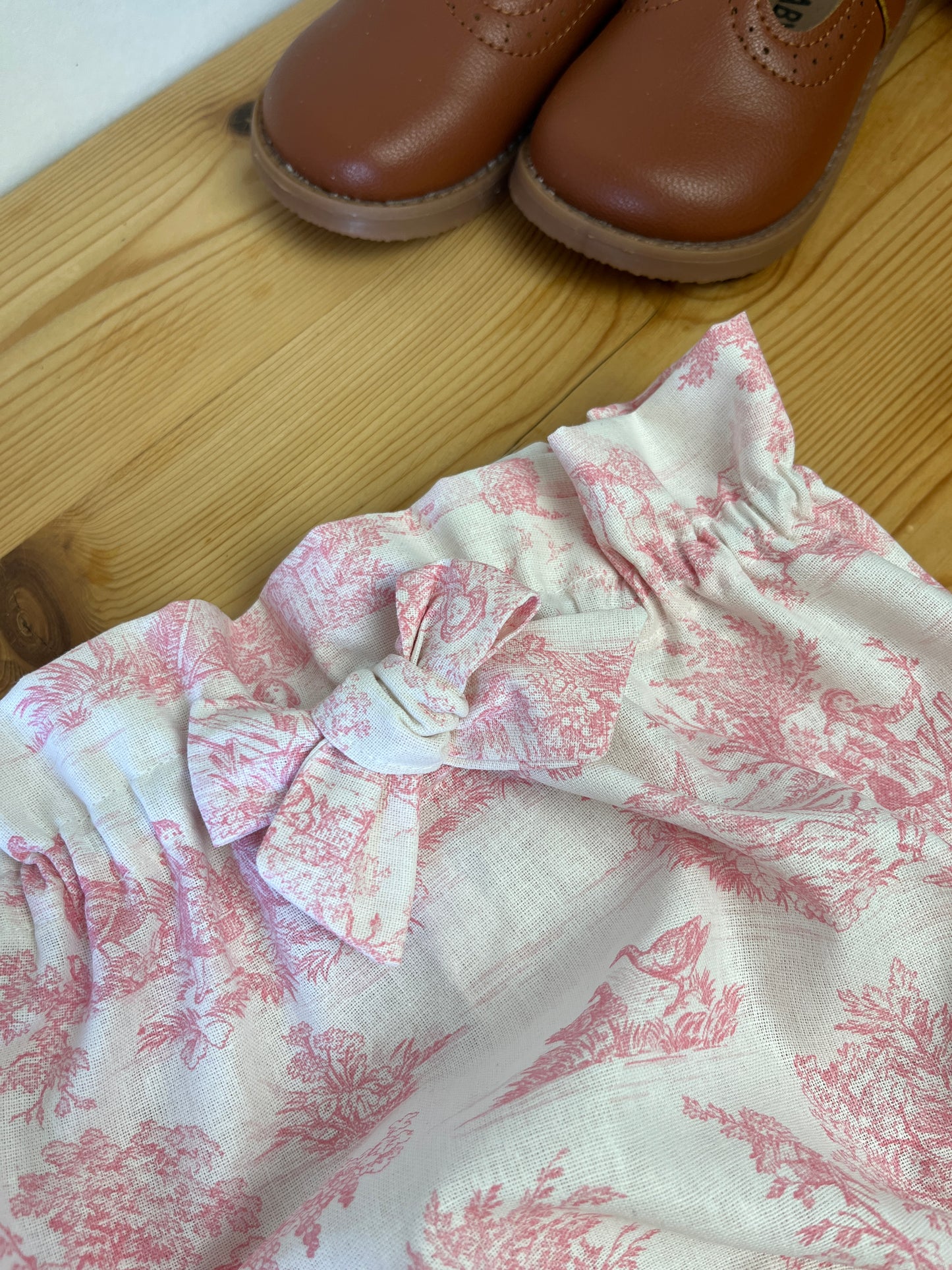 Set includes: diaper bag, notebook cover, doll, bloomers, and headband