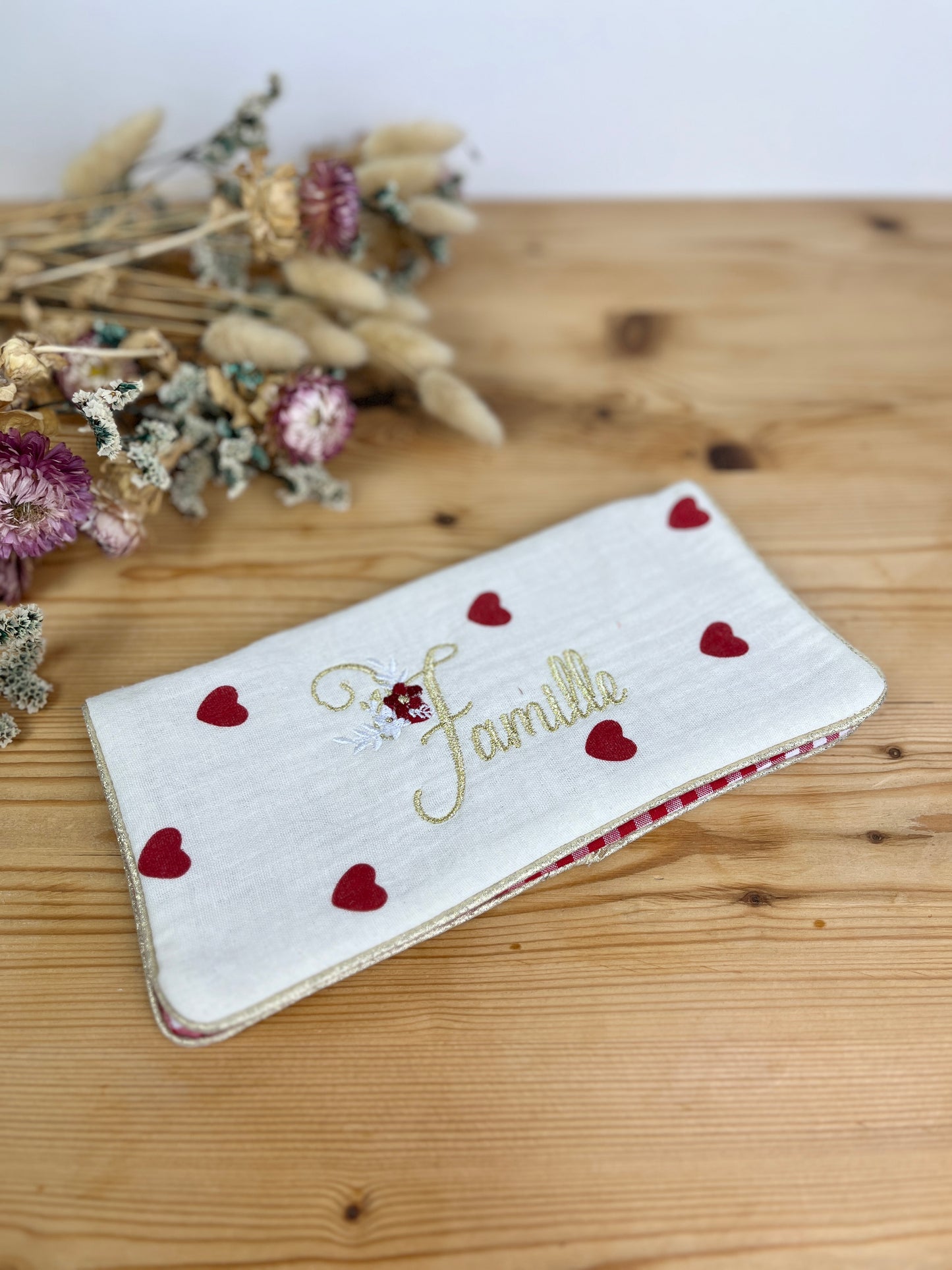 Embroidered family record book cover with heart design
