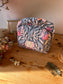 Colette's quilted toiletry bag and its bow