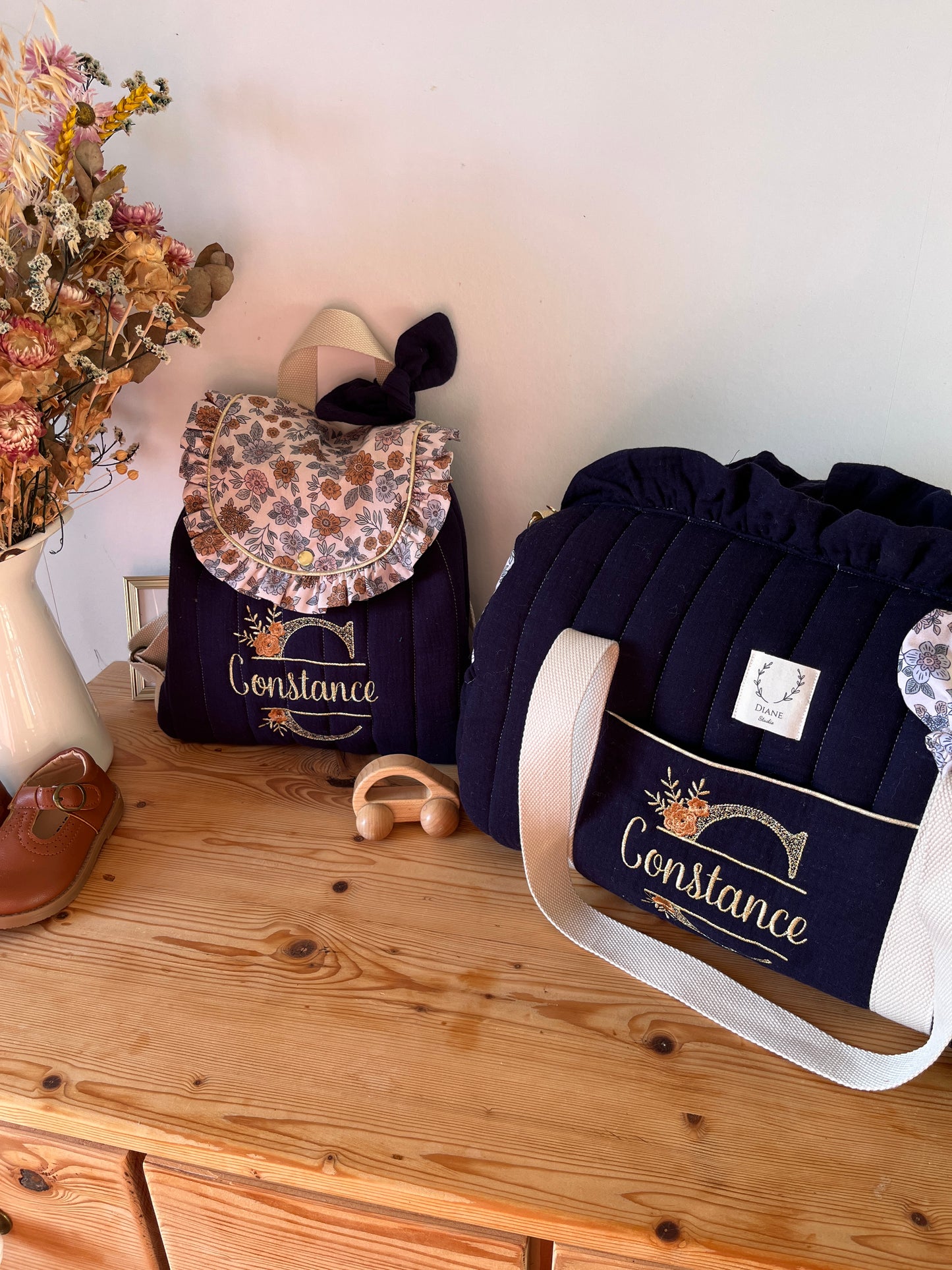 Set: Eglantine duffel bag and backpack with initial lace