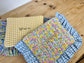 Quilted flat clutch bag in yellow gingham and Liberty of London