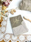 Set includes: Toiletry bag, blanket, doll, notebook cover, and bonnet 