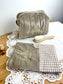Set includes: Toiletry bag, blanket, doll, notebook cover, and bonnet 
