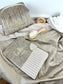 Set includes: Toiletry bag, blanket, doll, notebook cover, and bonnet 