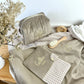 Set includes: Toiletry bag, blanket, doll, notebook cover, and bonnet 