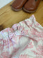 Set includes: diaper bag, notebook cover, doll, bloomers, and headband 