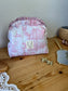 Colette's quilted toiletry bag and its bow