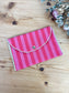 The pink and red striped coin purse has a Liberty print interior.