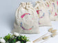 Cream-colored pouch with a golden floral initial
