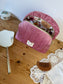 Set includes: Toiletry bag, blanket, doll, notebook cover, and bonnet 