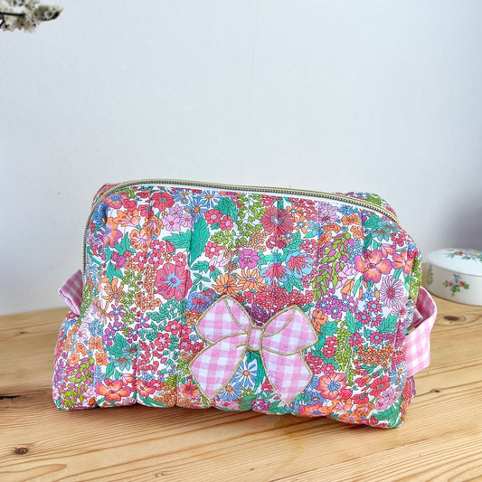 Colette's quilted toiletry bag and its bow