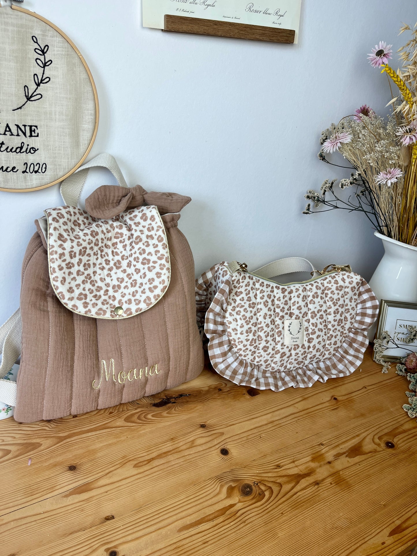 Set includes: Toiletry bag, blanket, doll, notebook cover, and bonnet 