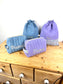 Set includes: Diaper bag, toiletry bag, doll, notebook cover, pouch and bonnet 