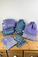Set includes: toiletry bag, doll, notebook cover and embroidered pouch 