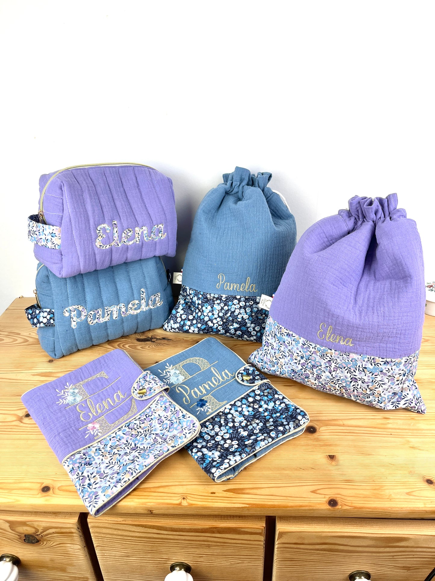 Set includes: Diaper bag, toiletry bag, doll, notebook cover, pouch and bonnet 