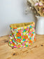 Children's poppy neck warmer with yellow background and glittery interior