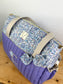 Set includes: Diaper bag, toiletry bag, doll, notebook cover, pouch and bonnet 