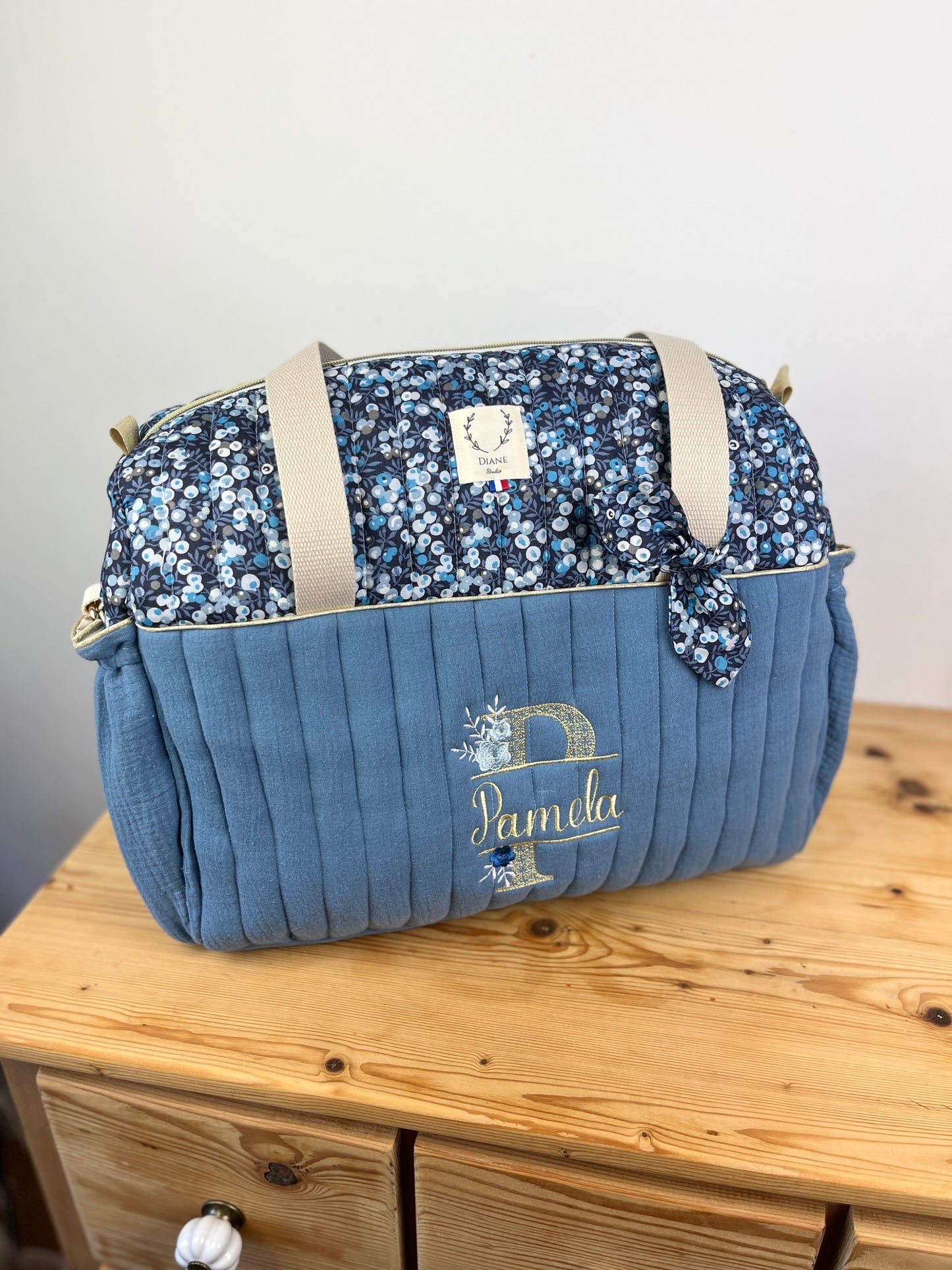 Set includes: Diaper bag, toiletry bag, doll, notebook cover, pouch and bonnet 