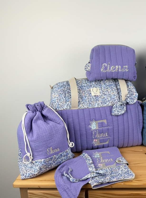 Set includes: Diaper bag, toiletry bag, doll, notebook cover, pouch and bonnet 