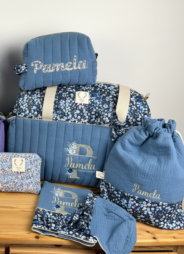 Set includes: Diaper bag, toiletry bag, blanket, doll, notebook cover, pouch and bonnet 