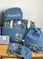 Set includes: Diaper bag, toiletry bag, blanket, doll, notebook cover, pouch and bonnet 
