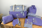 Set includes: Diaper bag, toiletry bag, blanket, doll, notebook cover, pouch and bonnet 