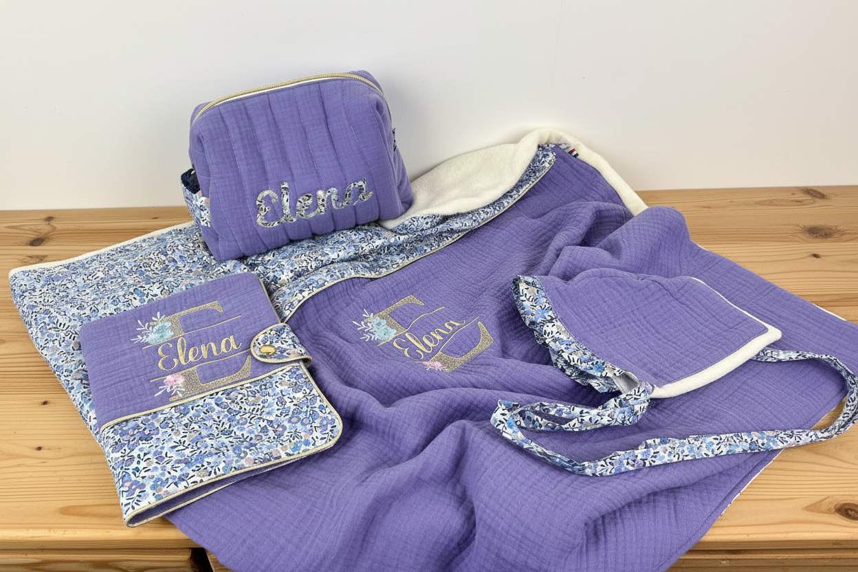 Set includes: Toiletry bag, blanket, doll, notebook cover, and bonnet 